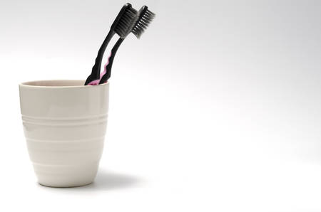 tooth brush in glass on a white backgroundの写真素材