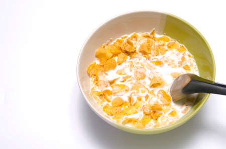 corn flakes in bowl on a white backgroundの写真素材