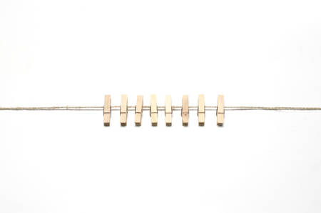 cloth pin hang with rope on a white の写真素材