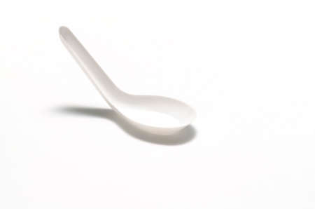 white plastic spoon on a white backgroundの写真素材