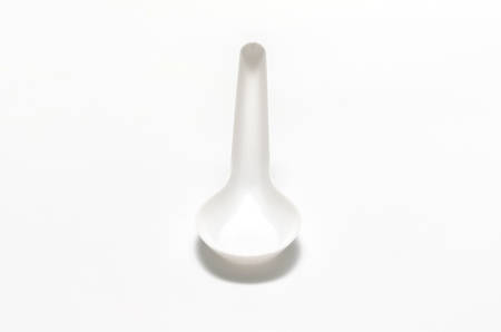 white plastic spoon on a white backgroundの写真素材