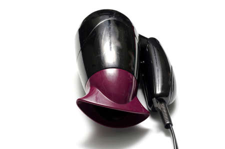 old used electric hair dryer on a white backgroundの写真素材
