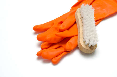wash brush and orange gloves on a white backgroundの写真素材