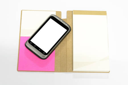 used smartphone with note book on a white background