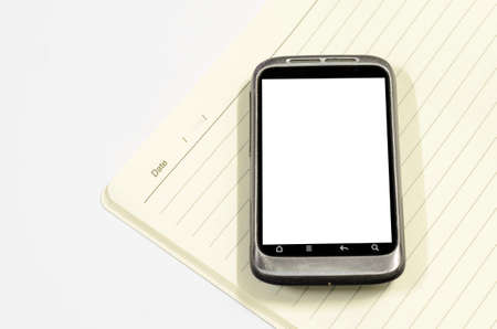 smartphone with note book on a white backgroundの写真素材