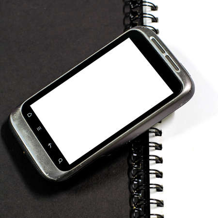 smartphone on note book on a white background