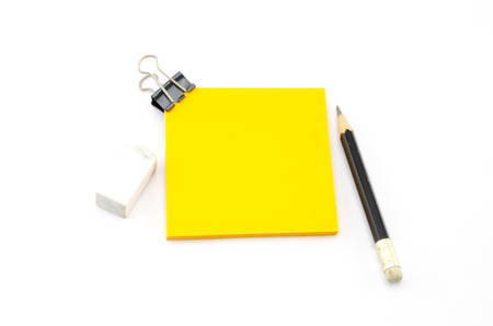 orange sticky note with black pencil isolated on white background