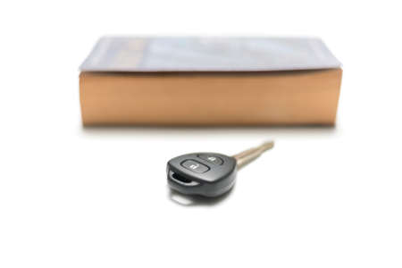 car key with book isolated on white backgroundの写真素材