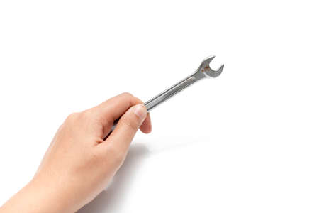 hand holding wrench isolated on white backgroundの写真素材