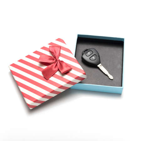 car key and gift box isolated on white backgroundの写真素材