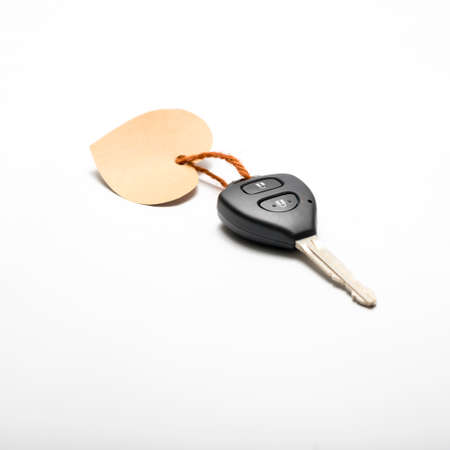 car key and heart tag isolated on white backgroundの写真素材