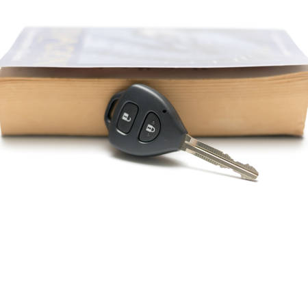 car key with book isolated on white backgroundの写真素材