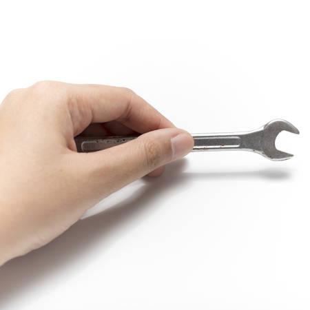 hand holding wrench isolated on white backgroundの写真素材