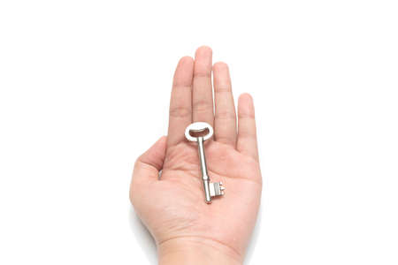 hand holding key isolated on white backgroundの写真素材