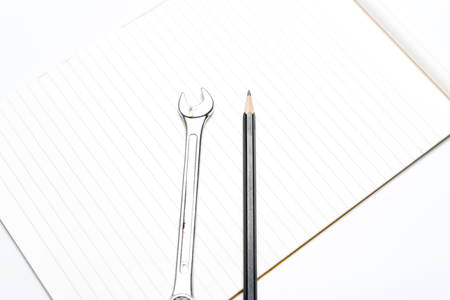 wrench with pencil on notebookの写真素材