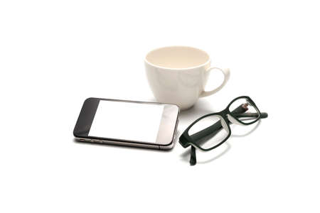 smart phone and eyeglasses with coffee cup isolated on white backgroundの写真素材