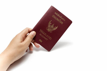 hand holding a passport isolated on white backgroundの写真素材