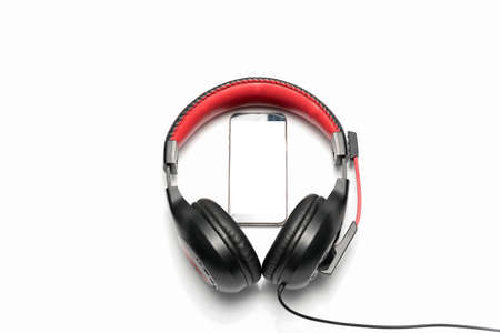 smart phone in head phone isolated on white backgroundの写真素材