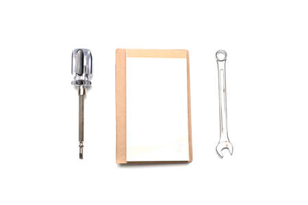 wrench notebook and screwdriver isolated on white backgroundの写真素材