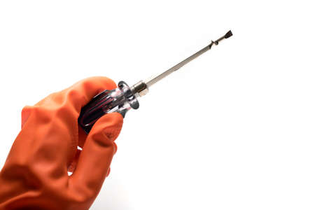 hand in orange glove holding screwdriver isolated on white backgroundの写真素材