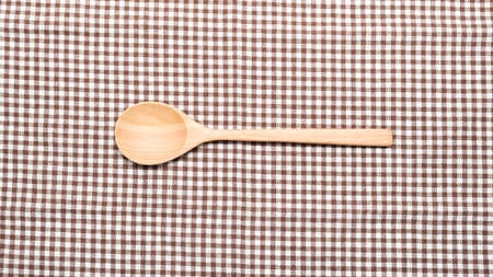 wood spoon on kitchen towel backgroundの写真素材