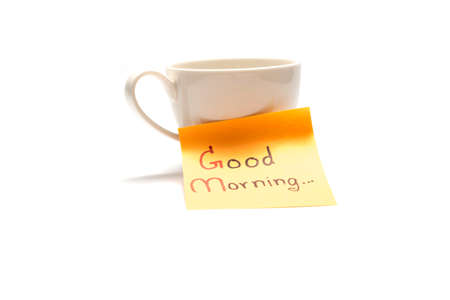 coffee cup with sticky note write Good morning isolated on white backgroundの写真素材