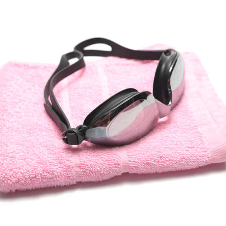 towel and swimming goggles isolated on white backgroundの写真素材