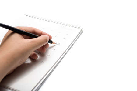 writing on calendar isolated on white backgroundの写真素材