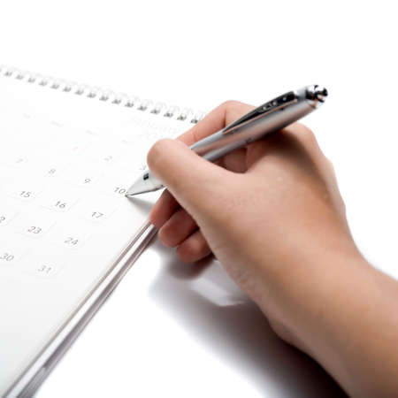 writing on calendar isolated on white backgroundの写真素材