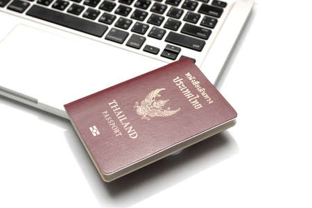 passport on laptop isolated on white background