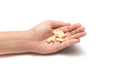 pills in hand isolated on white background