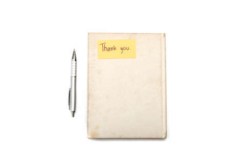 Thank you card on notebook and pen isolated on white backgroundの写真素材
