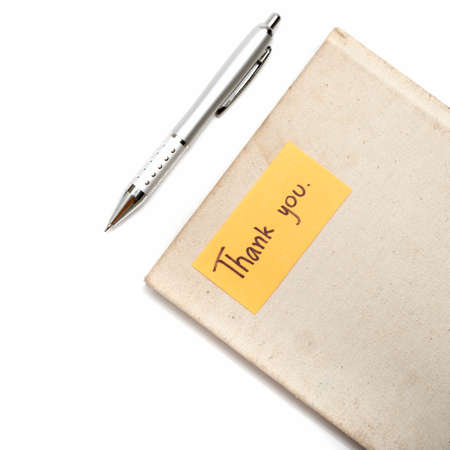 Thank you card on notebook and pen isolated on white backgroundの写真素材