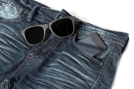 sunglasses and smartphone on jean pant concept man accessoriesの写真素材