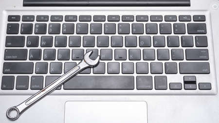 wrench on laptop concept fixing it