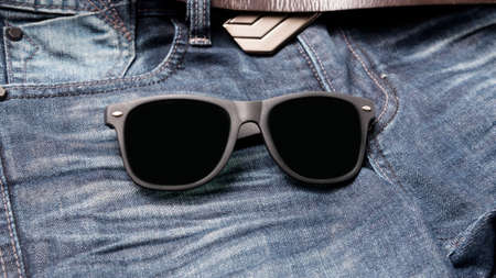 sunglasses on jean pantsの写真素材