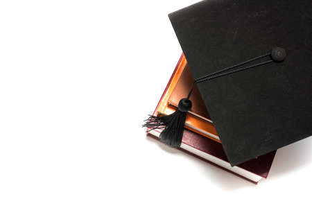graduation cap and book isolated on white backgroundの写真素材