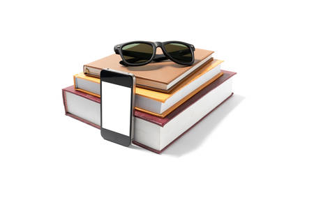 sunglasses smartphone and stack of book isolated on white backgroundの写真素材