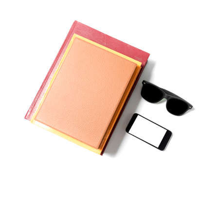 sunglasses smartphone and stack of book isolated on white backgroundの写真素材