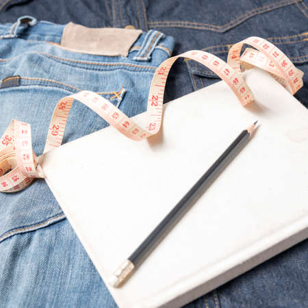 measuring tape and notebook with jeanの写真素材