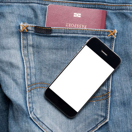 passport in jean pocket with smart phoneの写真素材