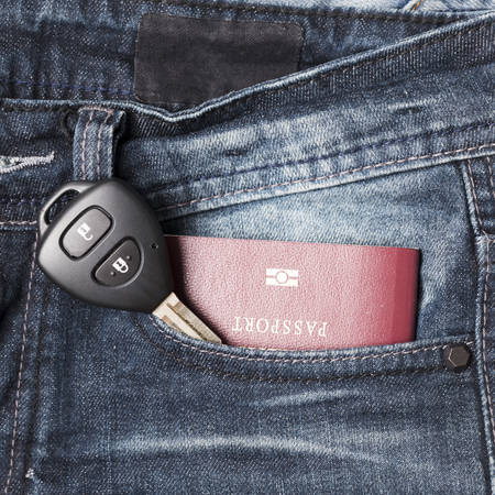 passport in jean pocket with car keyの写真素材