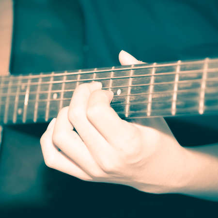 still life man playing guitar close up vintage style