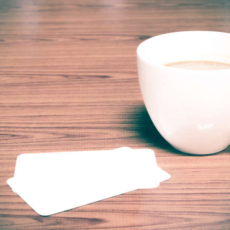 coffee cup and business card on wood background vintage styleの写真素材