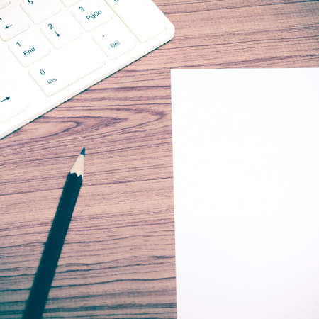 keyboard computee white paper and black pencil on wood background vintage style