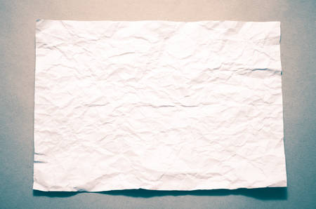 a4 size white crumpled paper on brown color background vintage styleの写真素材