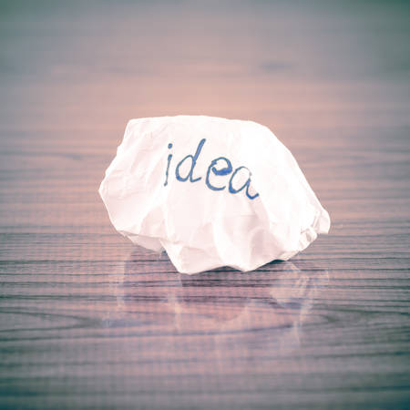writing idea word on crumpled on wood background