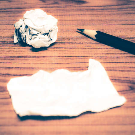paper scrap and crumpled with pencil on wood background vintage style