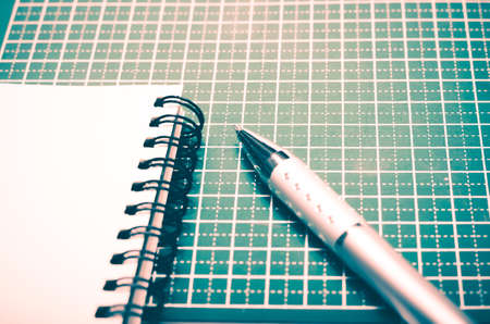 notebook and pen on green cutting mat vintage style