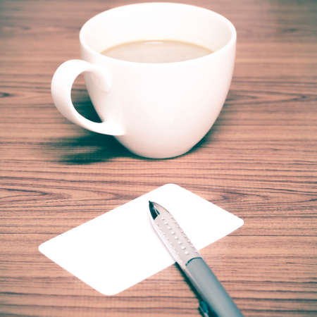 coffee cup and business card on wood background vintage styleの写真素材